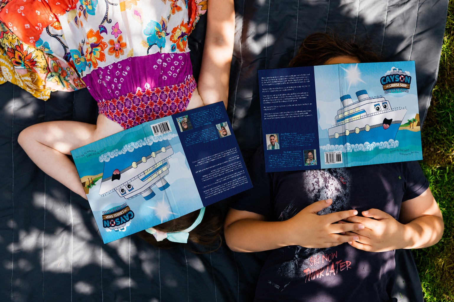 Children relaxing outdoors with copies of Cayson the Cruise Ship